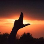 Hand in Laker "L" shape in front of a sunset. on March 20, 2026